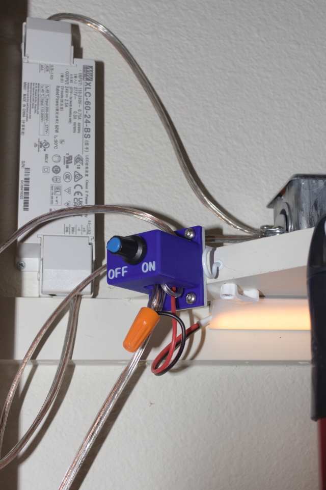 Meanwell XLC-60 behind dimmer switch, with pigtail used to put two 12V strips in series hanging out