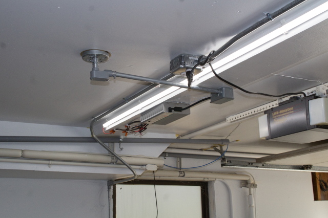 Garage LED strip, showing conduit running from old light fixture to 24V DC power supply